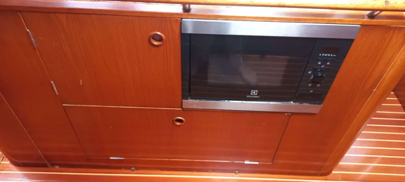 Roxanne Yacht Photos Pics Wooden interior of 1990 Beneteau Oceanis Clipper 500 with built-in microwave.