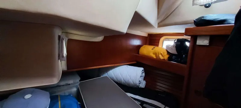 Roxanne Yacht Photos Pics Cozy cabin interior of 1990 Beneteau Oceanis Clipper 500 with storage and bedding.
