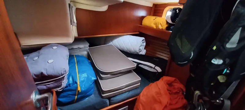 Roxanne Yacht Photos Pics Cozy cabin storage in 1990 Beneteau Oceanis Clipper 500 sailboat, with neatly packed gear.