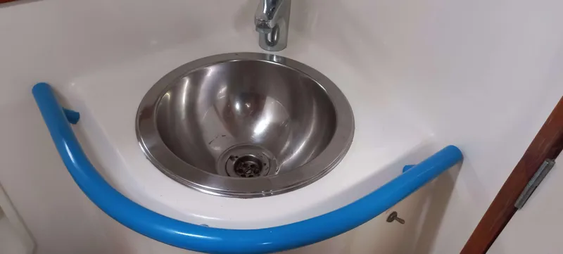 Roxanne Yacht Photos Pics Stainless steel sink with blue handrail on Beneteau Oceanis Clipper 500 yacht, 1990 model.