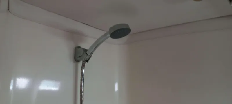 Roxanne Yacht Photos Pics Showerhead in Beneteau Oceanis Clipper 500 yacht, 1990 model, white interior.