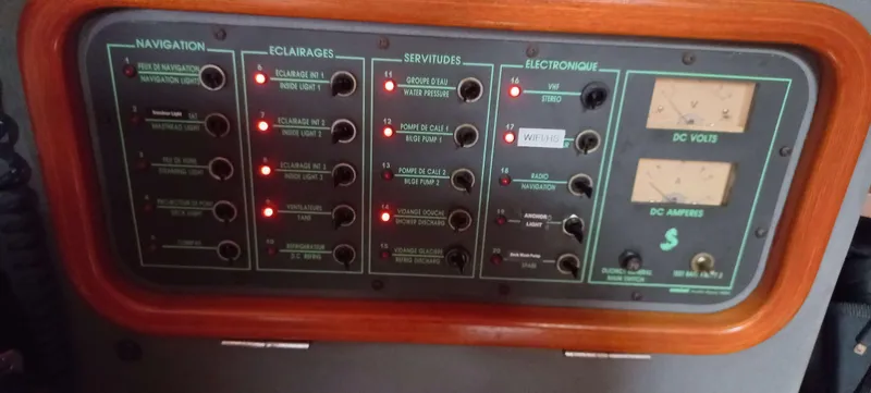 Roxanne Yacht Photos Pics Control panel of a 1990 Beneteau Oceanis Clipper 500 sailboat with illuminated switches.