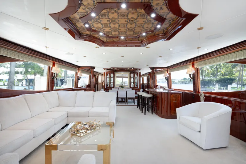Lady Kristina Yacht Photos Pics Luxurious interior of 2004 Lazzara LY106 yacht with elegant seating and wooden accents.