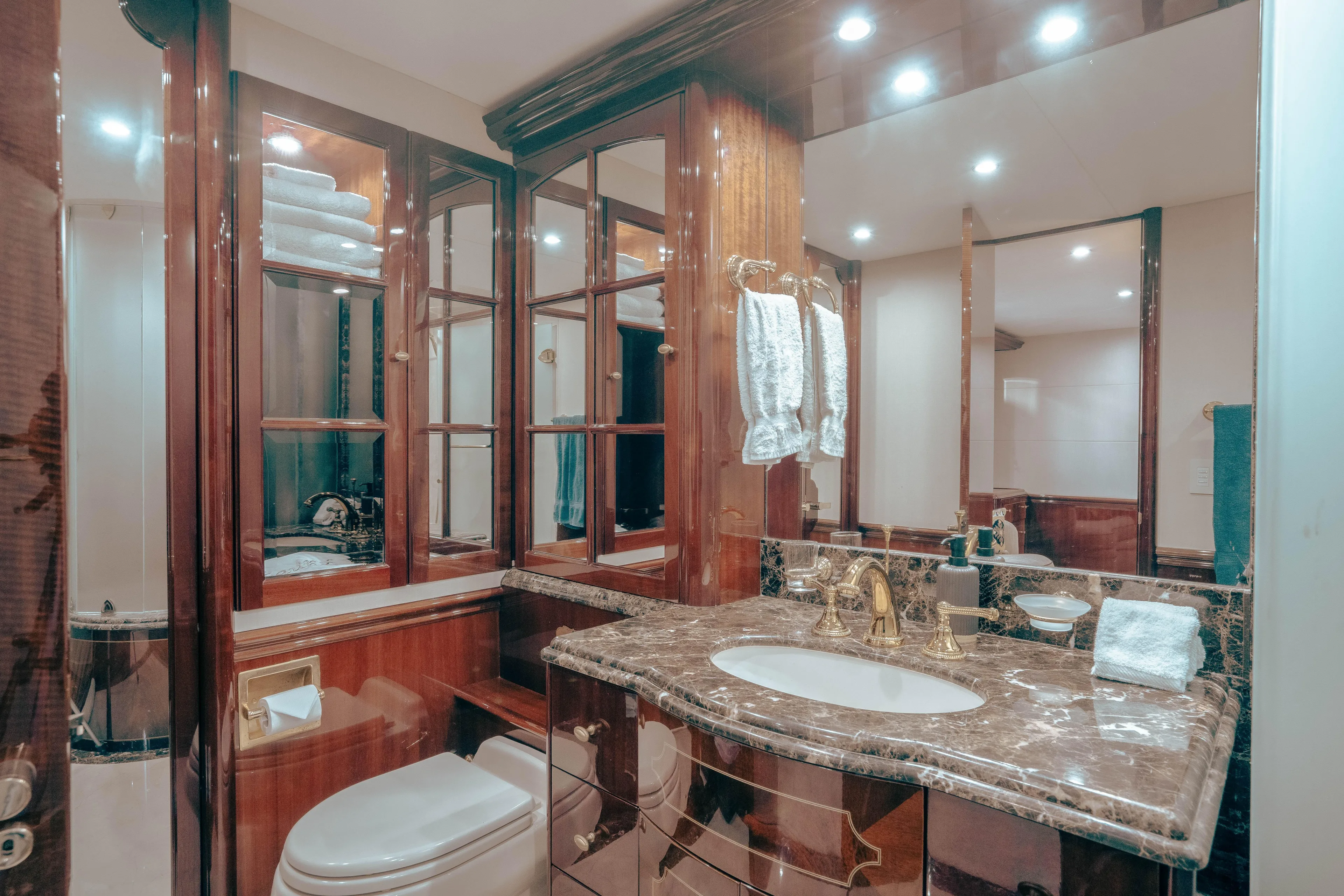 Lady Kristina Yacht Photos Pics Luxurious bathroom in 2004 Lazzara LY106 yacht with marble countertop and elegant wood cabinetry.