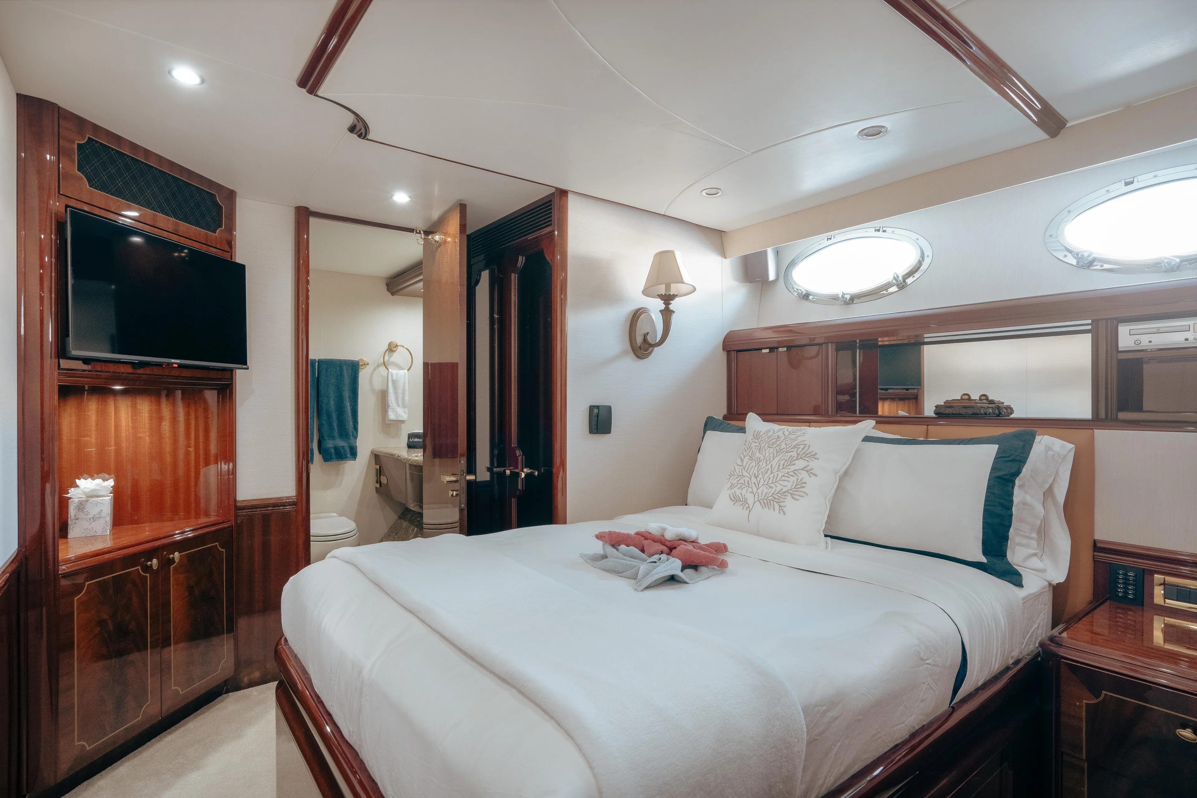 Lady Kristina Yacht Photos Pics Luxurious 2004 Lazzara LY106 yacht bedroom with elegant wood finishes and modern amenities.