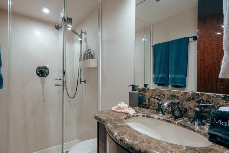 Lady Kristina Yacht Photos Pics Luxurious bathroom in 2004 Lazzara LY106 yacht with marble countertop and glass shower.