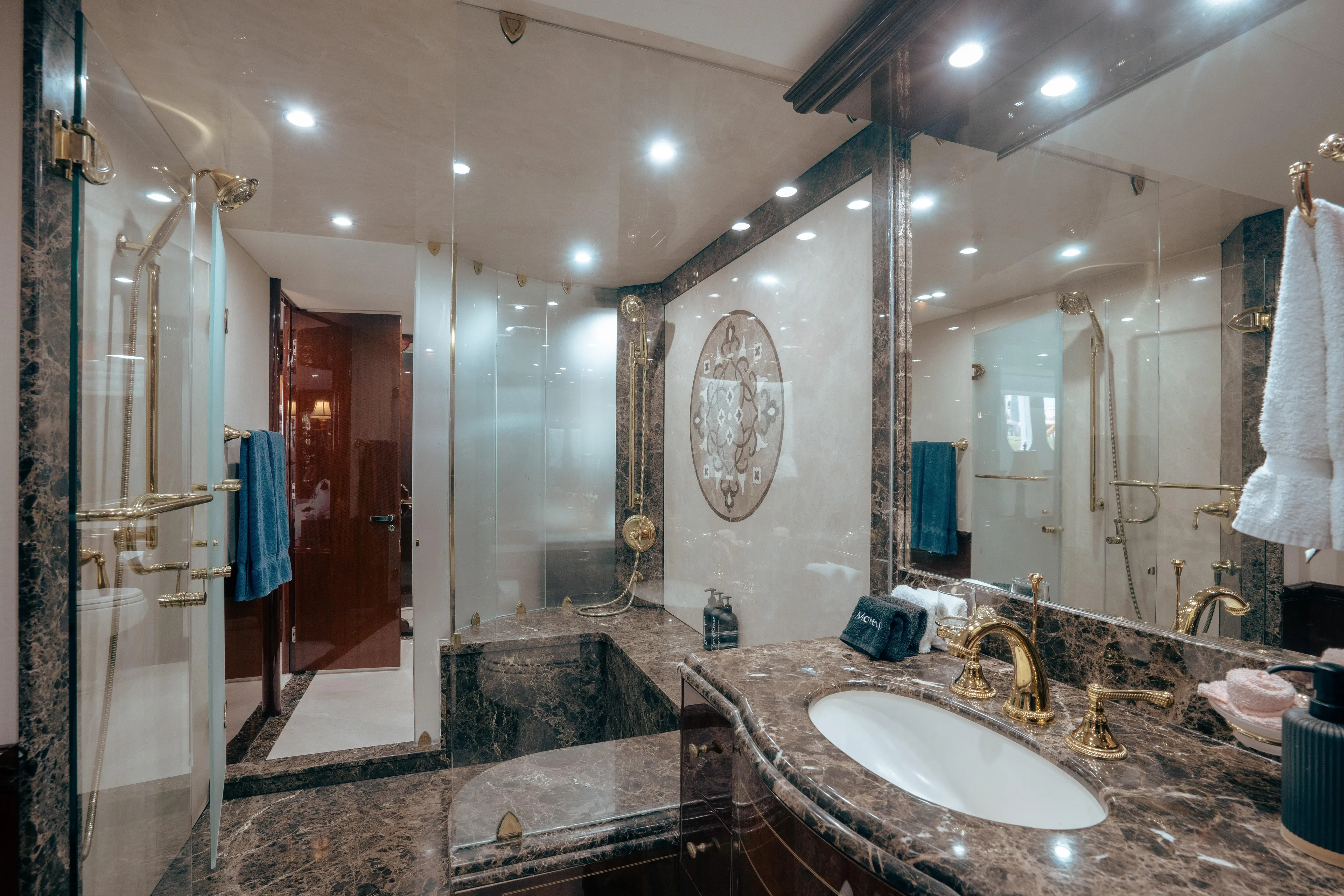 Lady Kristina Yacht Photos Pics Luxurious bathroom in 2004 Lazzara LY106 yacht with marble and gold accents.