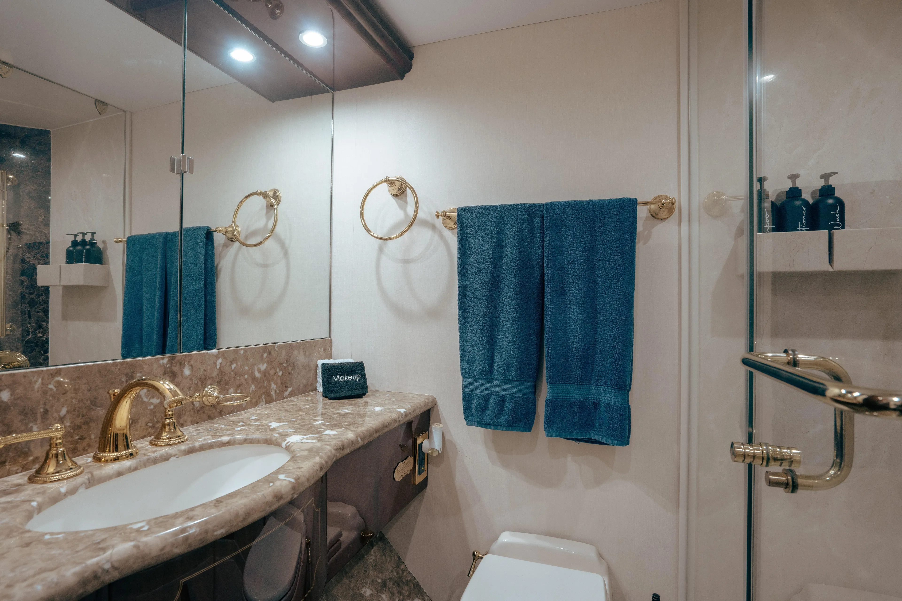 Lady Kristina Yacht Photos Pics Luxurious bathroom in 2004 Lazzara LY106 yacht with marble countertop and gold fixtures.