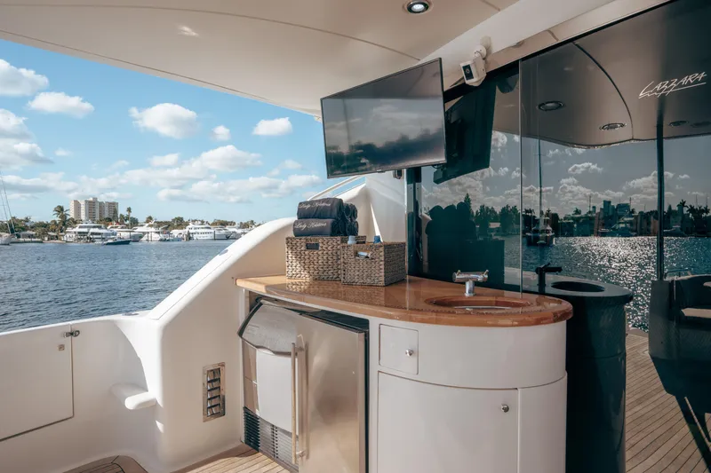 Lady Kristina Yacht Photos Pics Luxurious 2004 Lazzara LY106 yacht deck with sink, TV, and ocean view.
