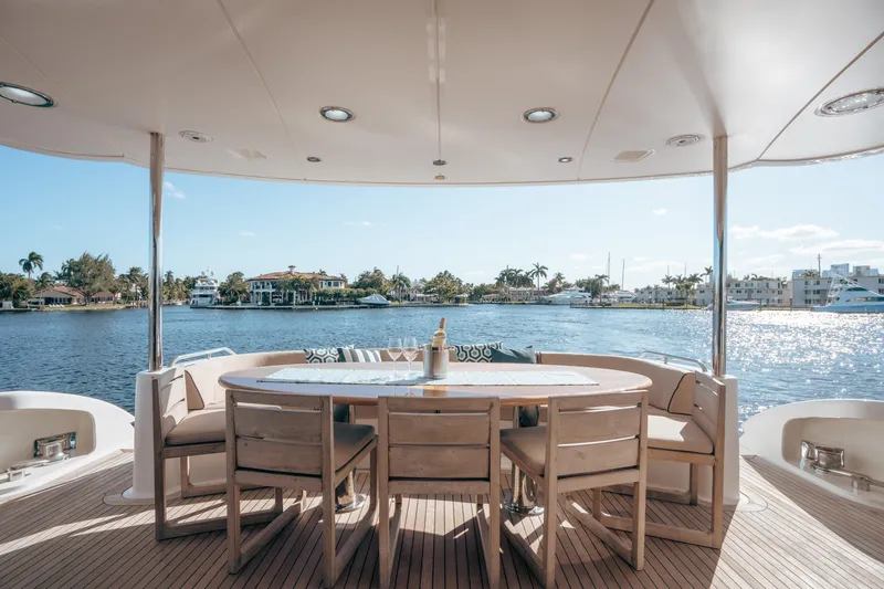 Lady Kristina Yacht Photos Pics Luxurious 2004 Lazzara LY106 yacht deck with elegant dining area overlooking serene waterfront.