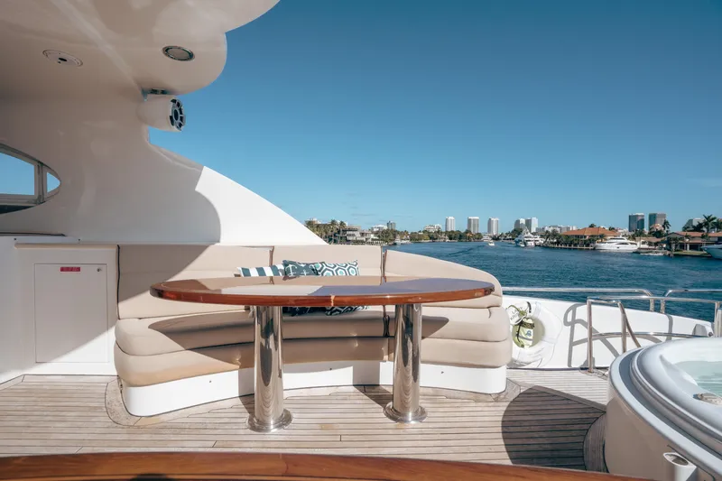 Lady Kristina Yacht Photos Pics Luxurious 2004 Lazzara LY106 yacht deck with seating, table, and waterfront view.