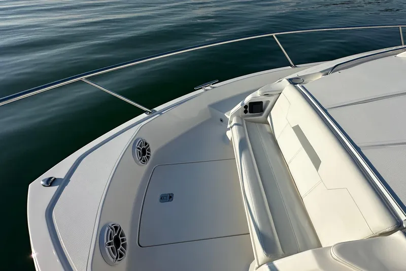  Yacht Photos Pics 2024 Pursuit OS 445 Offshore boat deck with seating and speakers on calm water.