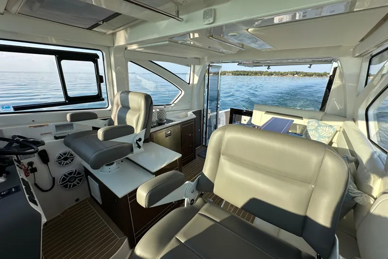  Yacht Photos Pics 2024 Pursuit OS 445 Offshore interior with luxurious seating and ocean view.