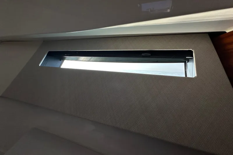  Yacht Photos Pics 2024 Pursuit OS 445 Offshore cabin window with sleek interior design.