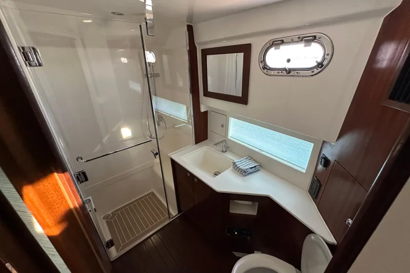  Yacht Photos Pics Luxurious bathroom in 2024 Pursuit OS 445 Offshore yacht with modern fixtures and elegant design.