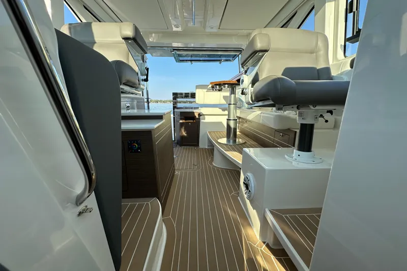  Yacht Photos Pics 2024 Pursuit OS 445 Offshore interior with modern seating and sleek design.
