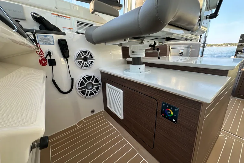  Yacht Photos Pics 2024 Pursuit OS 445 Offshore boat interior with modern controls and seating.