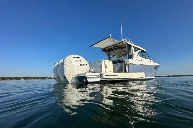  Yacht Photos Pics 2024 Pursuit OS 445 Offshore boat with Yamaha XTO engines on calm water.