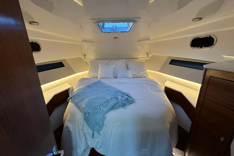  Yacht Photos Pics Luxurious cabin interior of 2024 Pursuit OS 445 Offshore yacht with cozy bedding.