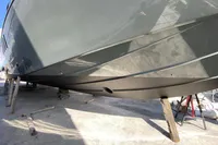 2004 Mangusta 80 Open yacht hull on dry dock, showcasing sleek design and craftsmanship.