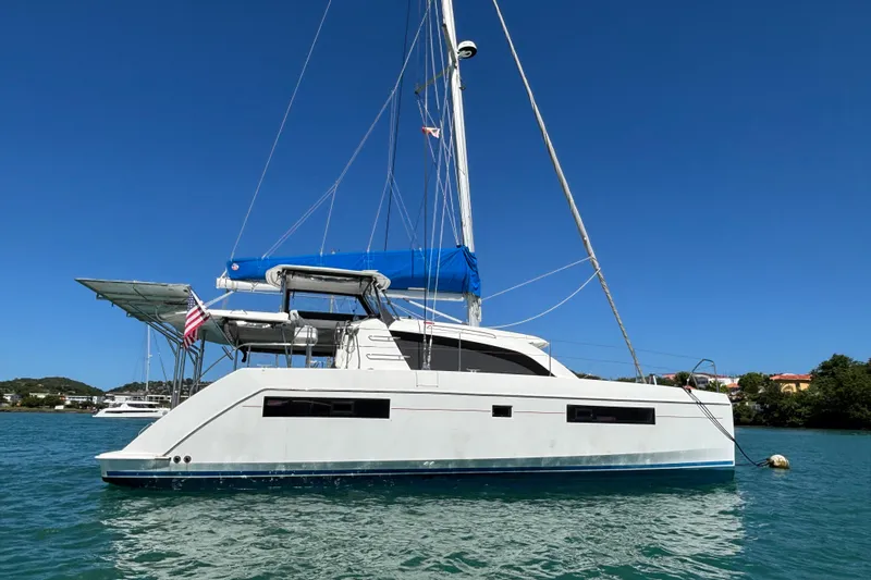  Yacht Photos Pics 2016 Leopard 40 catamaran sailing on clear blue water under a sunny sky.