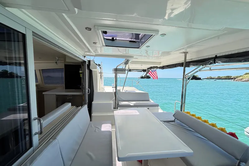  Yacht Photos Pics Leopard 40 catamaran interior with ocean view, featuring seating and dining area, 2016 model.