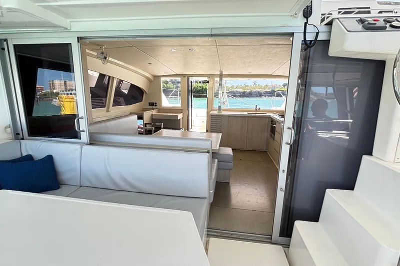  Yacht Photos Pics Interior view of 2016 Leopard 40 catamaran with modern seating and ocean backdrop.