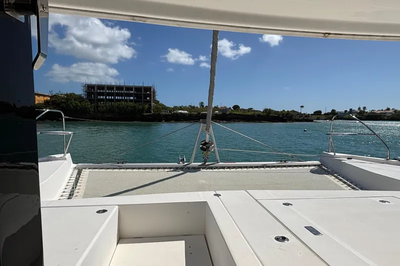  Yacht Photos Pics Leopard 40 catamaran deck view, 2016 model, overlooking serene waters and distant shoreline.