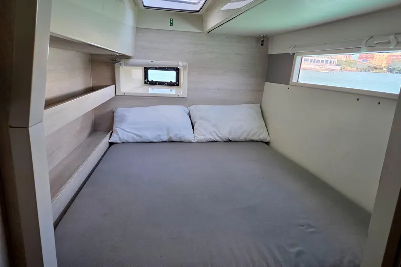  Yacht Photos Pics Cozy cabin interior of 2016 Leopard 40 catamaran with comfortable bedding and scenic window views.