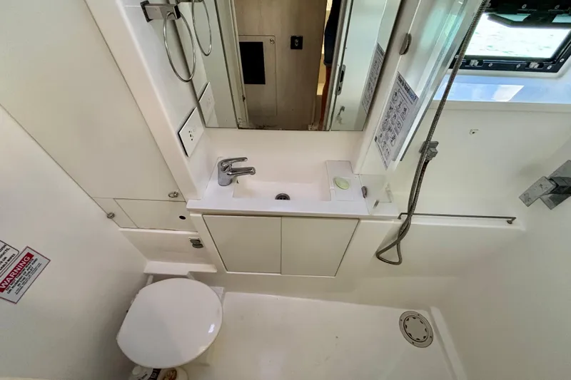  Yacht Photos Pics Bathroom interior of a 2016 Leopard 40 catamaran, featuring a compact sink and toilet.