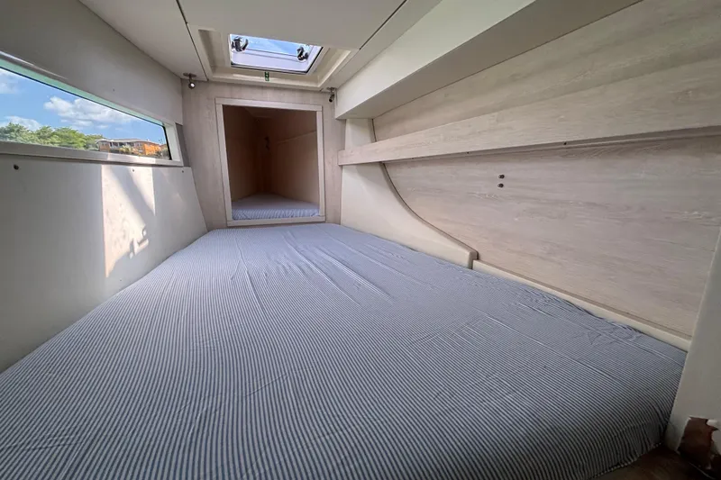  Yacht Photos Pics Interior cabin of 2016 Leopard 40 catamaran with striped bedding and skylight.