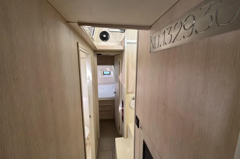  Yacht Photos Pics Interior hallway of a 2016 Leopard 40 catamaran, featuring light wood paneling.