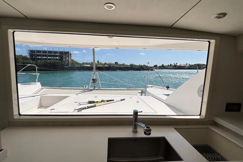  Yacht Photos Pics Interior view from a 2016 Leopard 40 catamaran, overlooking serene waters.