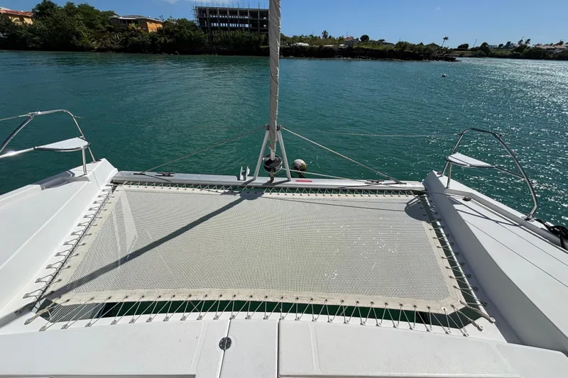  Yacht Photos Pics Front deck of 2016 Leopard 40 catamaran with netting over turquoise water.