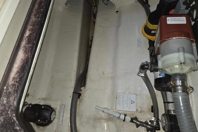  Yacht Photos Pics Engine compartment of a 2016 Leopard 40 catamaran, showing hoses and mechanical components.