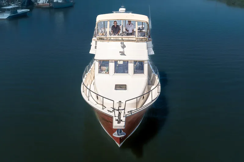 Coastal Fogg Yacht Photos Pics 2006 Mainship 34 Trawler cruising on calm water, viewed from the front.