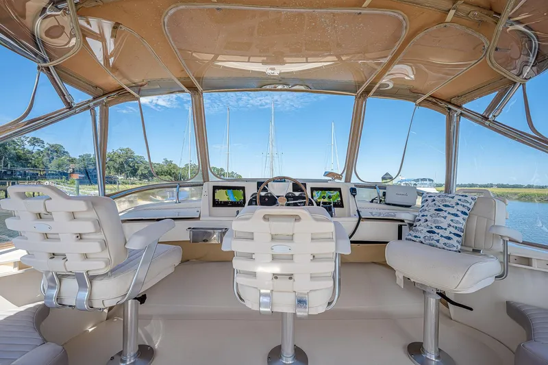 Coastal Fogg Yacht Photos Pics Interior view of 2006 Mainship 34 Trawler helm with navigation equipment and seating.