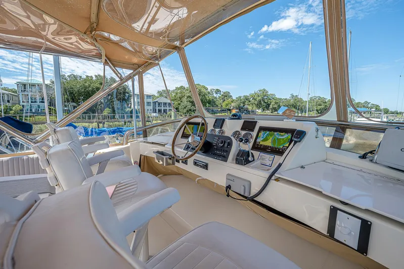 Coastal Fogg Yacht Photos Pics 2006 Mainship 34 Trawler helm with modern navigation equipment and comfortable seating.