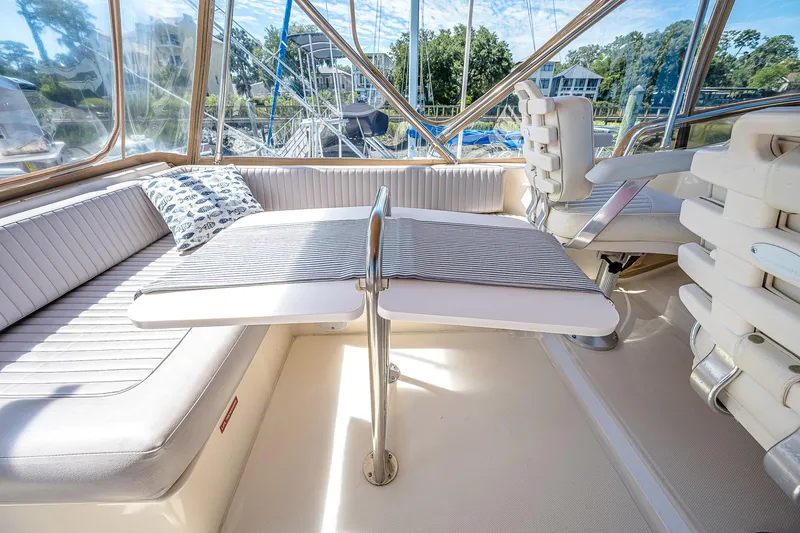 Coastal Fogg Yacht Photos Pics 2006 Mainship 34 Trawler interior with seating, table, and helm, showcasing luxury and comfort.