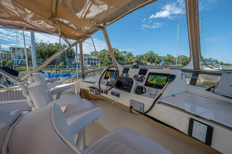 Coastal Fogg Yacht Photos Pics 2006 Mainship 34 Trawler helm with modern navigation equipment and comfortable seating.