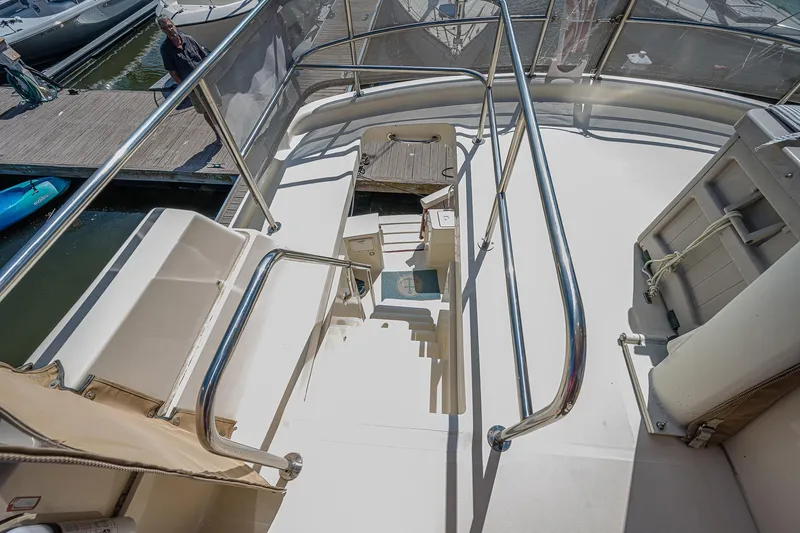 Coastal Fogg Yacht Photos Pics 2006 Mainship 34 Trawler deck with stairs and railing, docked at marina.