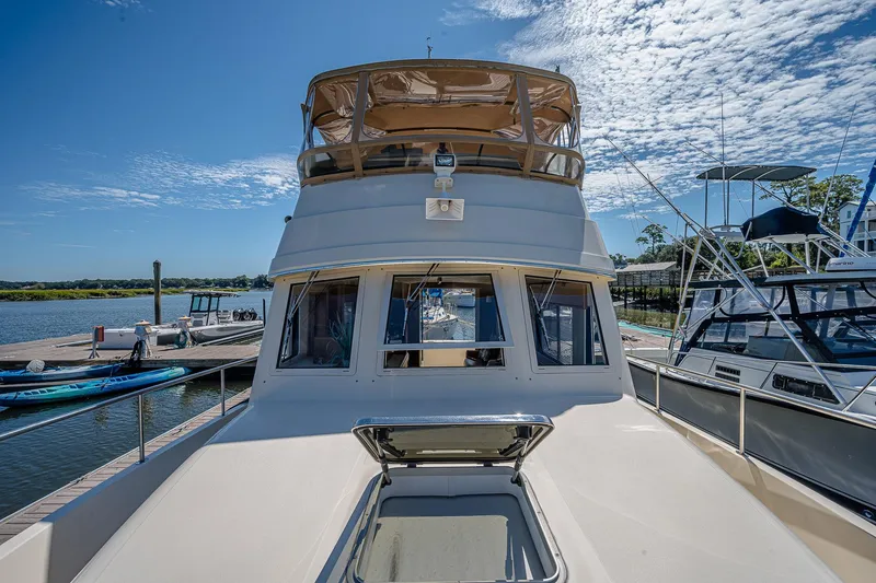 Coastal Fogg Yacht Photos Pics 2006 Mainship 34 Trawler docked at marina under clear blue sky.