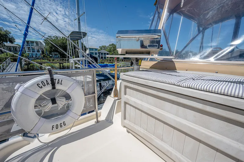 Coastal Fogg Yacht Photos Pics 2006 Mainship 34 Trawler deck with life preserver and cushioned seating.