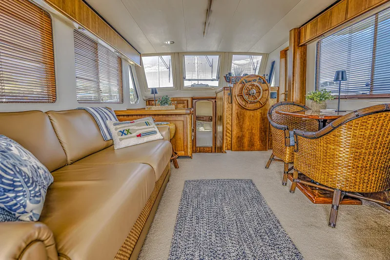 Coastal Fogg Yacht Photos Pics Interior of 2006 Mainship 34 Trawler with cozy seating and wooden helm.