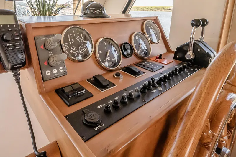 Coastal Fogg Yacht Photos Pics 2006 Mainship 34 Trawler helm with gauges, controls, and steering wheel.