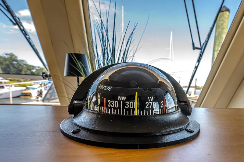 Coastal Fogg Yacht Photos Pics Compass on 2006 Mainship 34 Trawler, with marina view through windows.
