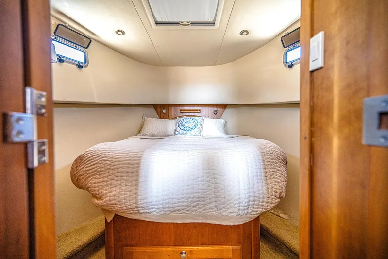 Coastal Fogg Yacht Photos Pics Cozy bedroom in 2006 Mainship 34 Trawler with plush bedding and natural light.
