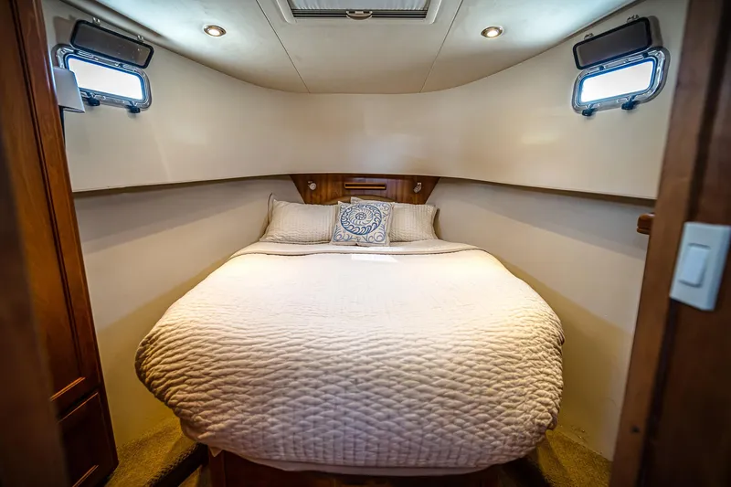Coastal Fogg Yacht Photos Pics Cozy bedroom in 2006 Mainship 34 Trawler with plush bedding and natural light.