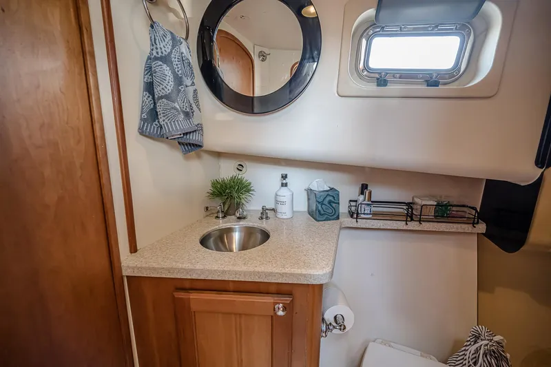 Coastal Fogg Yacht Photos Pics 2006 Mainship 34 Trawler bathroom with sink, mirror, and window.
