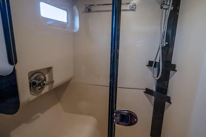 Coastal Fogg Yacht Photos Pics Shower area in 2006 Mainship 34 Trawler, featuring modern fixtures and compact design.